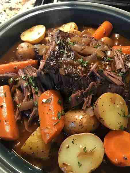 Season a chuck roast with salt and pepper, sear in a hot pan, then place in a slow cooker with diced...