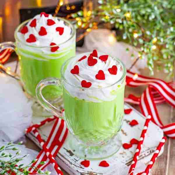 Homemade Grinch Hot Chocolate! 💖💚 Made right in the slow cooker! Swirl on some whipped cream & can...
