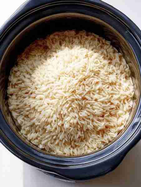 Put uncooked rice in a slow cooker with these 4 ingredients. It’s like heaven in a bowl.. Full recip...