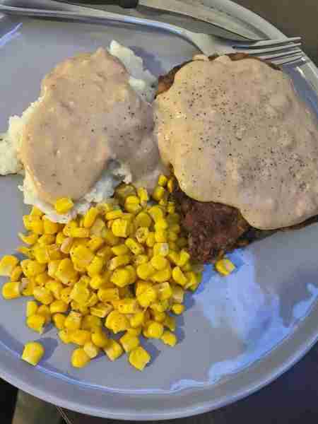 Chicken fried steak mashed potatoes and corn 😋