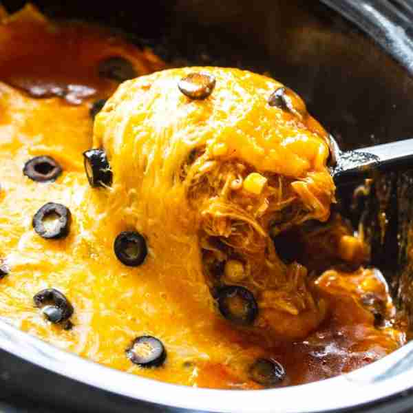 Crock Pot Chicken Enchilada Casserole is full of cheese, shredded chicken, corn, black beans, and to...