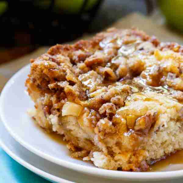 A moist and flavorful coffee cake studded with fresh apple chunks and with a crumb topping and brown...