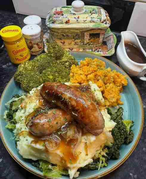 Sausage and mash on a bed of cabbage with caramelised onions broccoli swede and carrots extra gravy...
