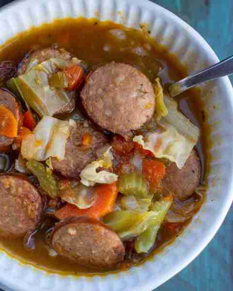 This Cabbage and Sausage Soup is the perfect way to warm up on a chilly night! This soup is rich, co...