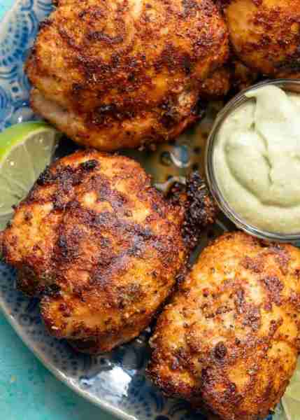 Make the best air fryer boneless chicken thighs with smoky blackened seasoning and refreshing avocad...
