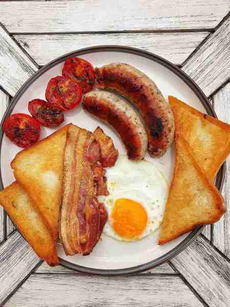 Brunch… Chive and Pork Sausages, Smoked Bacon, Fried Egg, Grilled Tomatoes with Dried Oregano and Fr...