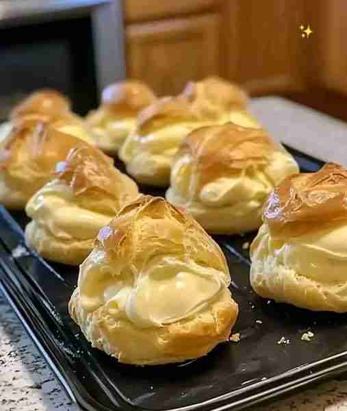 Easy Cream Puffs 🥐🍰 Light, airy, and filled with a luscious vanilla cream, these cream puffs are a...