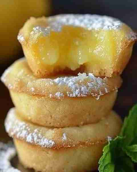 Mouthwatering Lemon Bar Cookie Cups 🍋💛 Ingredients: For the Cookies: 2¾ cups flour 1 teaspoon baki...