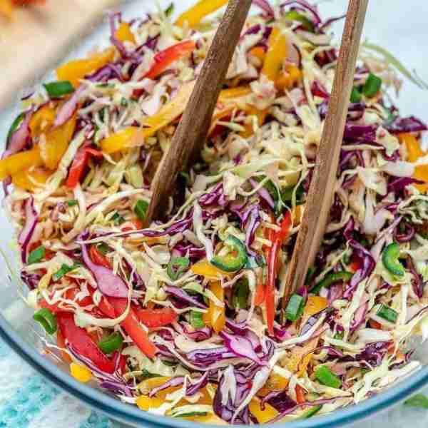 Sweet + Spicy Rainbow Slaw transforms veggies into a tangy bowl of goodness that you’ll actually CRA...