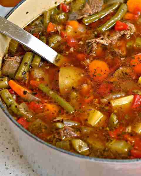 “Beef Vegetable Soup is made with tender chunks of slowly simmered chuck roast with onions, celery,...