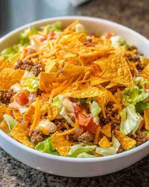Dorito Taco Salad Ingredients: 1 head iceberg lettuce, shredded 1 (16-ounce) bottle Catalina dressin...