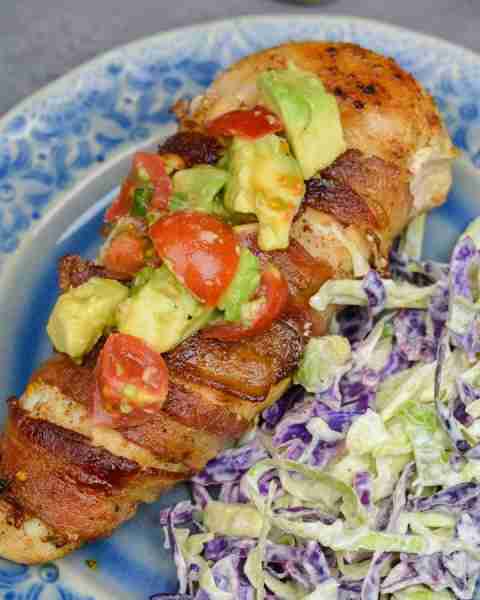 Enjoy Bacon Wrapped Chicken with Avocado Salsa for an easy weeknight meal! This low carb dish contai...