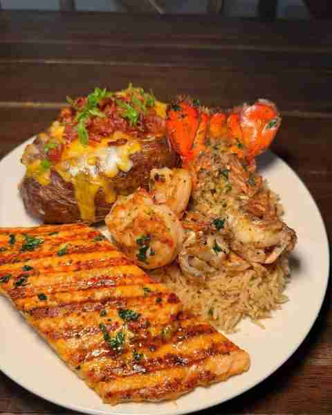 Surf and turf plate with salmon, lobster, and a baked potato! 🦞🥔🤤