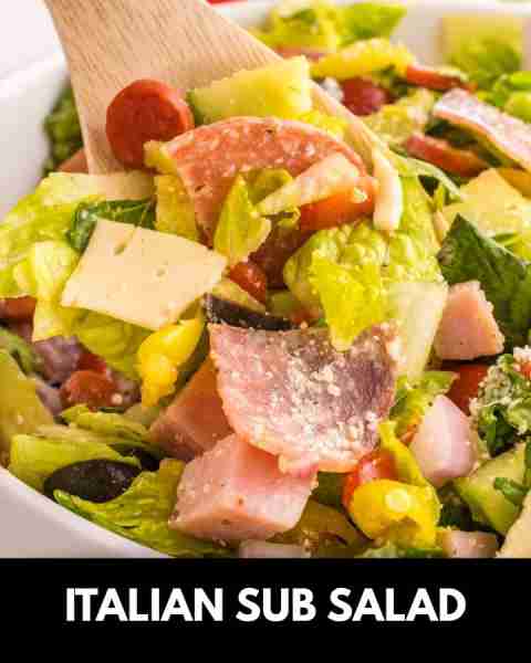 Italian Sub Salad is a delicious dish loaded with romaine, olives, tomatoes, cucumber, ham, pepperon...