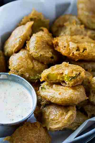 Beer Battered Fried Pickles are coated in a light and crispy beer batter. Serve with Spicy Ranch Dip...