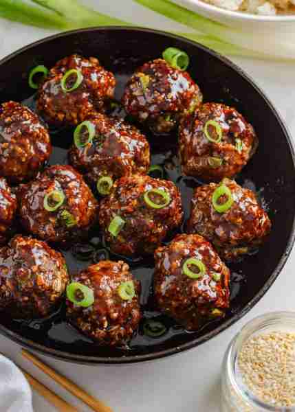 Korean meatballs are juicy beef meatballs made with garlic, ginger, and soy sauce then baked and sim...