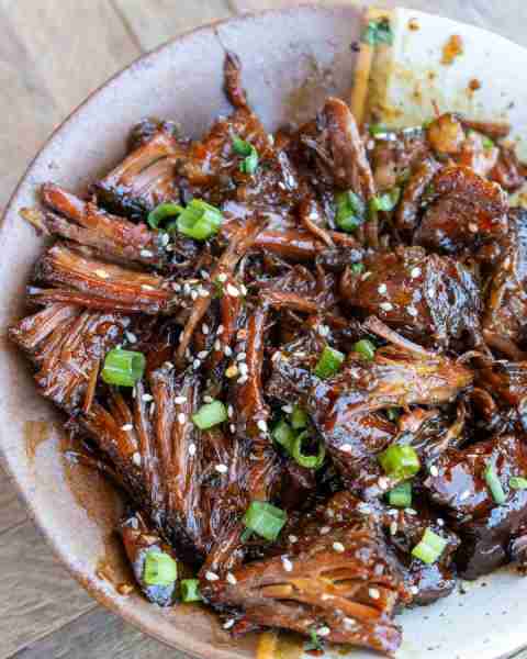 This easy slow cooker sweet and spicy shredded beef is the perfect low-maintenance dinner!