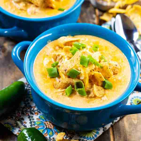 Slow Cooker White Chicken Chili is ultra creamy with lots of southwestern spices. Serve with Frito C...