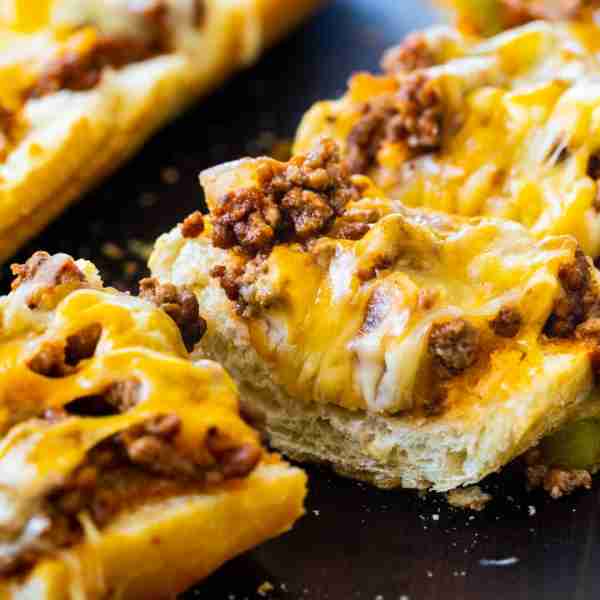 Sloppy Joe French Bread Pizza- a deliciously tangy and a little sweet sloppy joe filling is slathere...