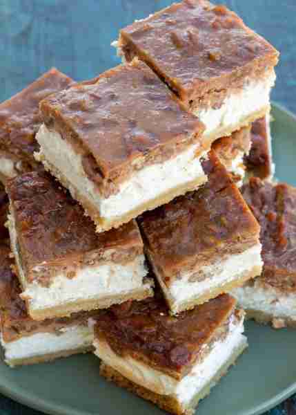 These Pecan Pie Cheesecake Bars feature a shortbread cookie crust, vanilla cheesecake and delicious...