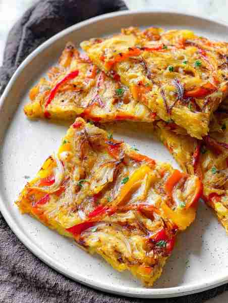 It’s like a garden baked into a golden crust — sweet peppers, caramelized onions, and that whisper o...