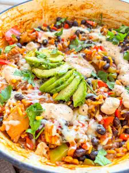 One-pot taco bowl😍 with black beans, spicy rice, lots of peppers and onions, and topped with avocad...