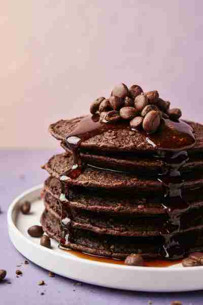 Coffee Chocolate Pancakes – Sweet Breakfast Bliss Fluffy Coffee Chocolate Pancakes drizzled with war...