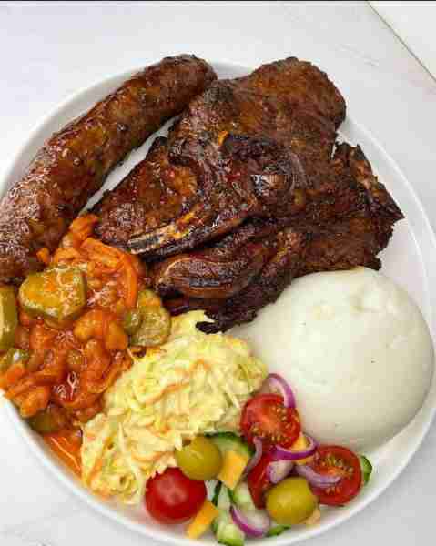 A Feast of Grilled Meat, Pap, and Vibrant Sides: A Celebration of Flavorful South African Cuisine Fu...