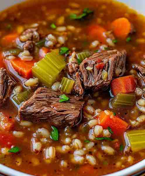 Beef Barley Soup is a delectable combination of beef, carrots, celery, onions, tomatoes, corn, and b...