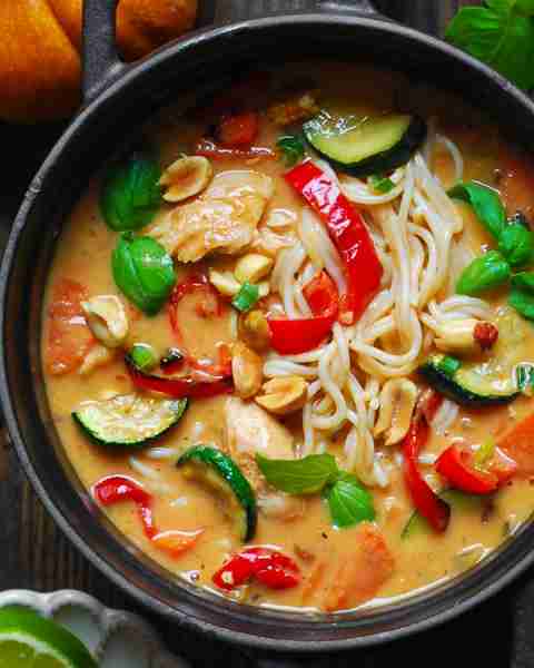 Thai-Inspired Coconut Curry Chicken Soup with Ramen Noodles, Bell Pepper, Zucchini, Carrots, and Oni...